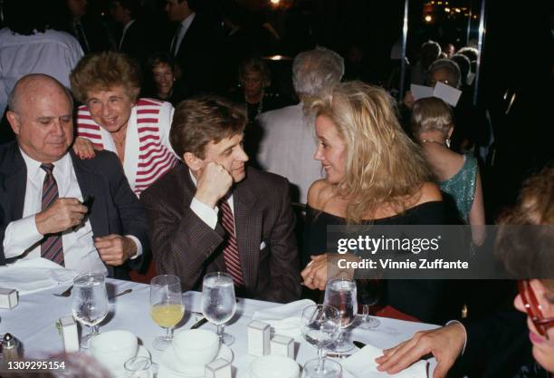 Soviet-born Latvian-American dancer, choreographer and actor Mikhail Baryshnikov, wearing a glen-check suit with a striped tie, in conversation with...