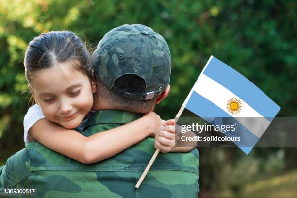 argentinian soldier and his daughter - argentinian flag stock pictures, royalty-free photos & images