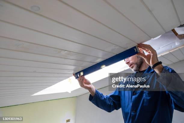 renovation of wooden roof panels at home - hand sawdust stock pictures, royalty-free photos & images