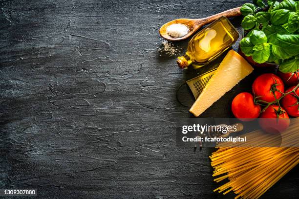 italian food: uncooked pasta and ingredients frame. copy space - italian restaurant interior stock pictures, royalty-free photos & images