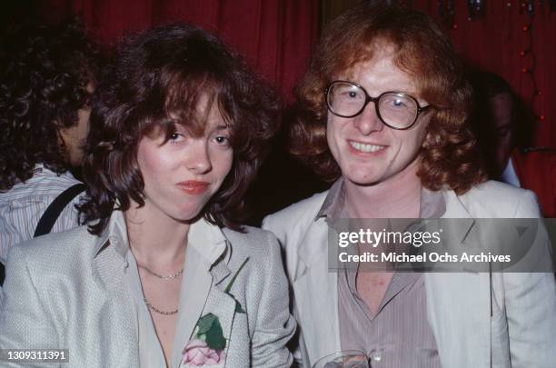 American actress and singer Mackenzie Phillips wearing a silver jacket with a pink flower in the buttonhole, and a white, open-neck blouse, with...