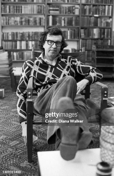 View of American author Larry McMurtry as he sits in his bookstore, Booked Up, late 1970s.