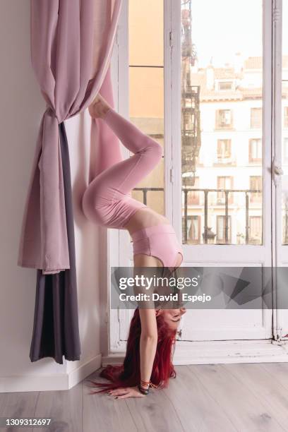beautiful sporty girl doing headstand yoga asana - shirshasana stock pictures, royalty-free photos & images