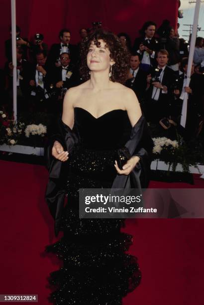 American actress Debra Winger, wearing an off-the-shoulder black evening gown with a black shawl, attends the 63rd Annual Academy Awards, held at the...