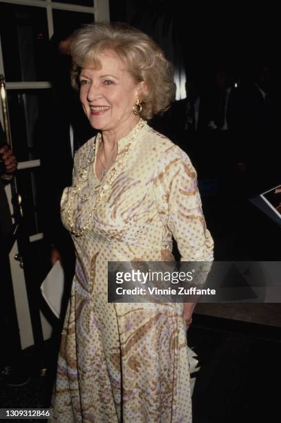 American actress and comedian Betty White, wearing yellow print pattern dress, smiling as she attends 5th Annual Genesis Awards, presented by the...