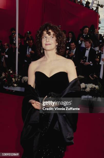 American actress Debra Winger, wearing an off-the-shoulder black evening gown with a black shawl, attends the 63rd Annual Academy Awards, held at the...