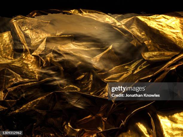 crinkled gold fabric - gold and black background stock pictures, royalty-free photos & images