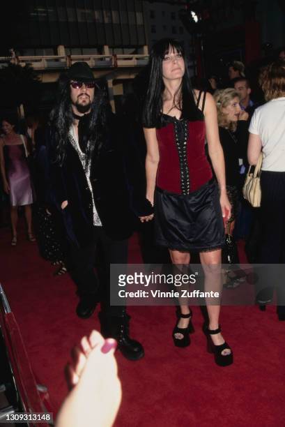 American singer-songwriter and filmmaker Rob Zombie and his partner, American actress Sheri Moon attend the premiere of 'Spawn', held at Mann's...