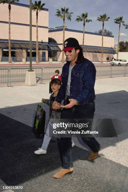 American actor Ken Wahl and his son, Raymond, both wearing denim jackets, attend the premiere of 'Teenage Mutant Ninja Turtles II: The Secret of the...