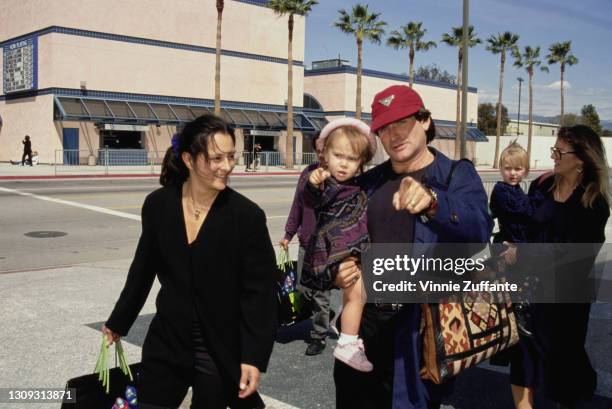 American film producer Marsha Garces Williams and her husband, American actor and comedian Robin Williams , carrying their daughter Zelda, attend the...