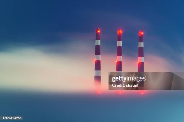 generating station chimneys in fog - chimney stock pictures, royalty-free photos & images