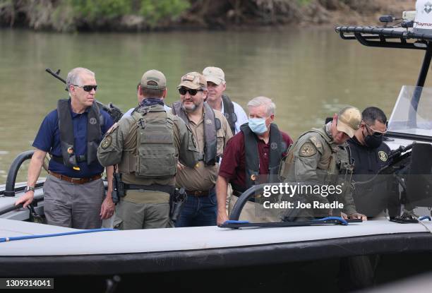 Sen. Ted Cruz and Sen. Lindsey Graham stand aboard a Texas Department of Public Safety boat for a tour of part of the Rio Grande river on March 26,...