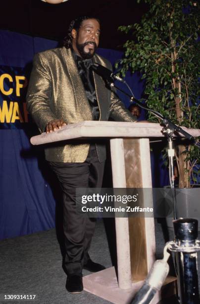 American singer-songwriter Barry White , wearing a gold jacket with a black shirt and black trousers, addresses the 21st Annual NAACP Image Awards,...