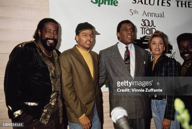 American singer-songwriter Barry White , wearing a black-and-gold jacket, American singer-songwriter Al B Sure!, wearing a tweed jacket over a yellow...