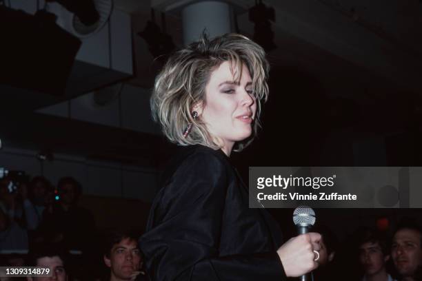 British singer Kim Wilde, dressed in black with a microphone in her right hand, performs in concert at Private Eyes, a nightclub in New York City,...