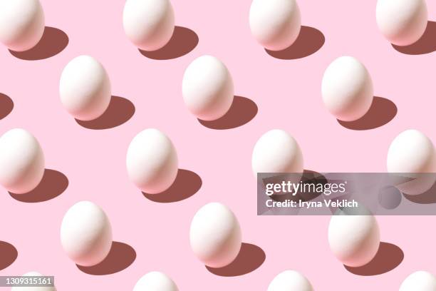 trendy pattern made of white easter egg on pastel pink background. - påskägg bildbanksfoton och bilder
