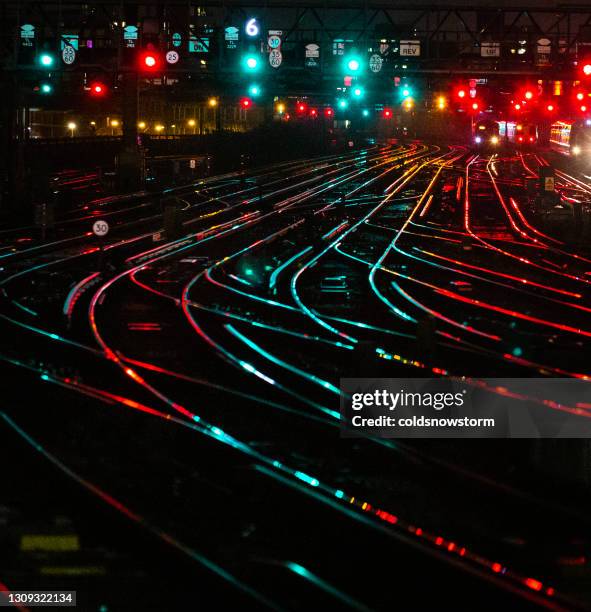 railway tracks illuminated at night in the city - rail stock pictures, royalty-free photos & images