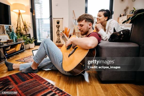 i like your melody - couple seated apartment hipster imagens e fotografias de stock