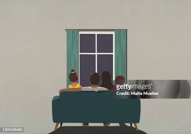 family on sofa looking out window at starry night sky - family stock illustrations