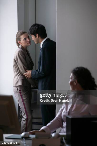 businessman cornering businesswoman at photocopier in office - sexual harassment stock pictures, royalty-free photos & images