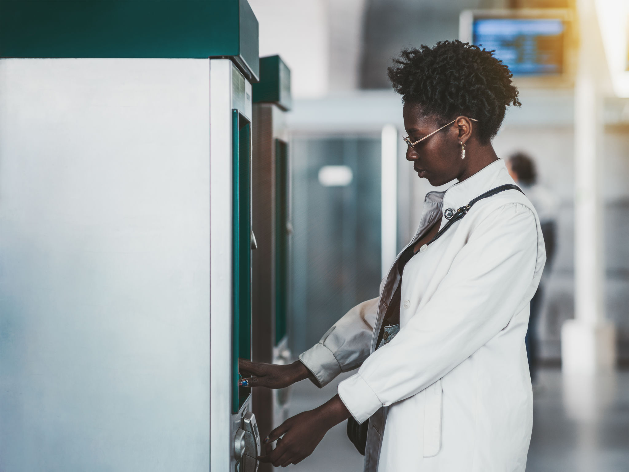 Black girl is using ATM Black girl is using ATM