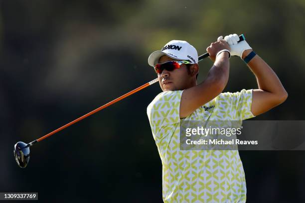 Hideki Matsuyama of Japan chips in on the 16th tee in his match against Patrick Cantlay of the United States during the third round of the World Golf...