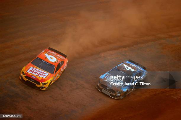Ryan Newman, driver of the Oscar Mayer Cold Cuts Ford, and Kevin Harvick, driver of the Busch Light Ford, race during practice for the NASCAR Cup...
