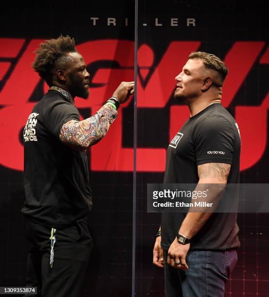 Steve Cunningham and Frank Mir joke around in a plexiglass box as they face off during a news conference for Triller Fight Club's inaugural 2021...