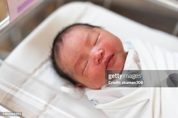 asian newborn baby  crying in cribs first day in the world - premature baby stock-fotos und bilder