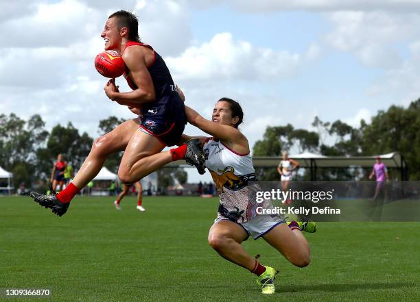 Karen Paxman of the Demons in action under pressure from Alexandra Anderson of the Lions during the round 9 AFLW match between the Melbourne Demons...