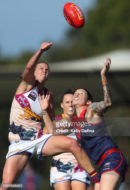 Kate Lutkins of the Lions and Tegan Cunningham of the Demons compete for the ball compete for the ball during the round 9 AFLW match between the...