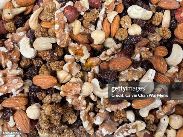 assorted mix nuts and dried fruits - dry fruits stock pictures, royalty-free photos & images