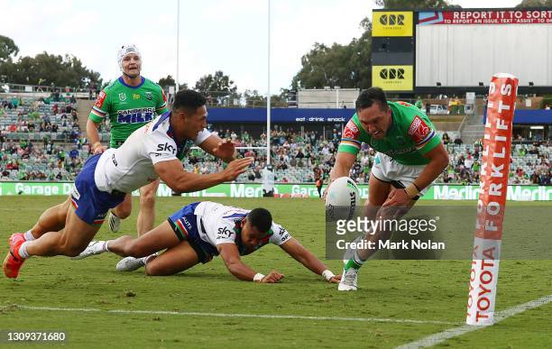 Roger Tuivasa-Sheck of the Warriors denies Jordan Rapana of the Raiders a try with a desperate diving tackle on full time during the round three NRL...