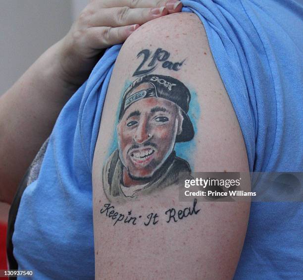 Fan shows her tattoo during Tupac's 40th Birthday Celebration at the Atlanta Symphony Hall on June 16, 2011 in Atlanta, Georgia.