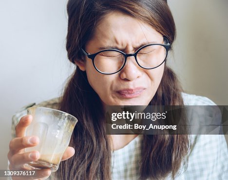 Facial expression of young Asian woman after drinking strong coffee. Facial expression of young Asian woman after drinking strong coffee.