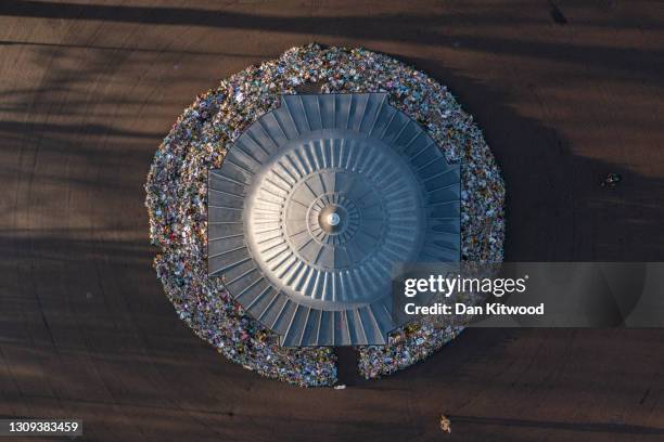 Flowers surround the Clapham Common bandstand memorial to murdered Sarah Everard on March 27, 2021 in London, England. Sarah Everard, a 33-year-old...