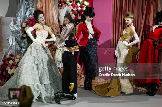 British fashion designer John Galliano pictured with models wearing his creations for the luxury fashion brand Dior during the winter haute couture...