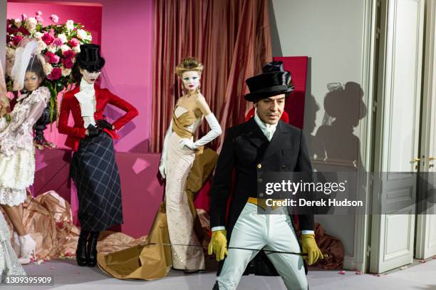 British fashion designer John Galliano pictured with models wearing his creations for the luxury fashion brand Dior during the winter haute couture...