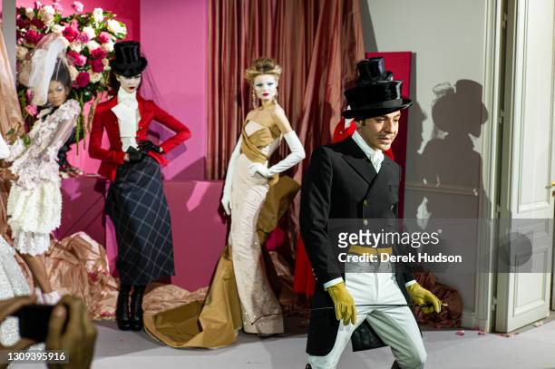 British fashion designer John Galliano pictured with models wearing his creations for the luxury fashion brand Dior during the winter haute couture...