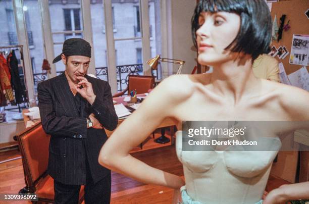 British fashion designer John Galliano pictured working with a fashion model and assistants during a fitting session in the original former wooden...