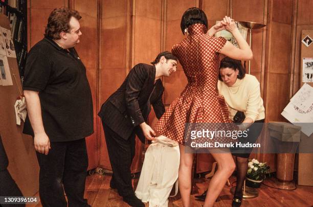 British fashion designer John Galliano pictured working with a fashion model and assistants during a fitting session in the original former wooden...