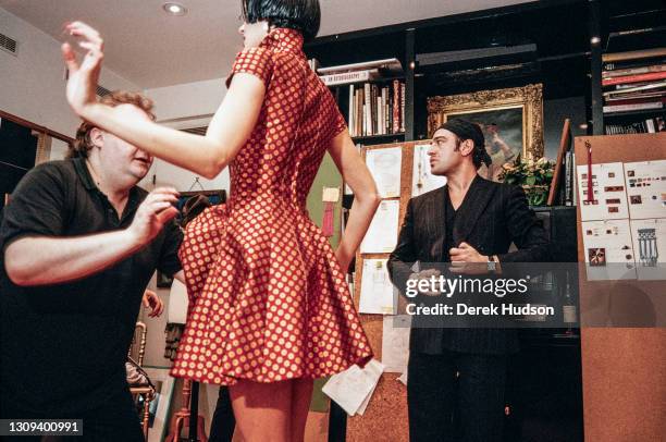 British fashion designer John Galliano pictured working with a fashion model and assistants during a fitting session in the original former wooden...