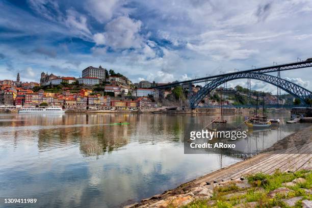 oporto, portugal, europe. postcard from the picturesque city of porto, amazing travel destination in portugal. view to the historic center, douro river with its beautiful bridge and old monuments. - dársena fotografías e imágenes de stock