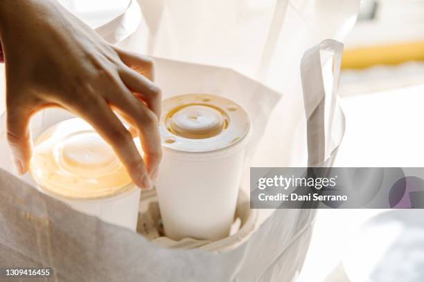 crop person taking out paper cups from bag - drinks carton - fotografias e filmes do acervo