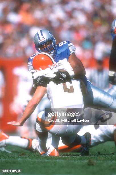 Tracy Scroggins of the Detroit Lions tackles Tom Couch of the Cleveland Browns during a NFL football game on September 30, 1994 at Cleveland...