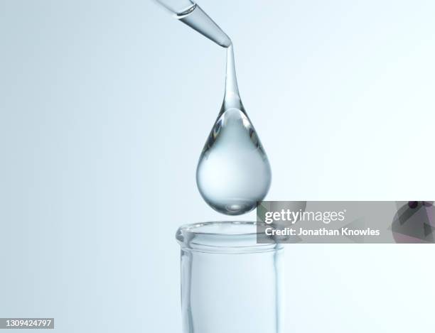 close up droplet over flask - science white background stockfoto's en -beelden