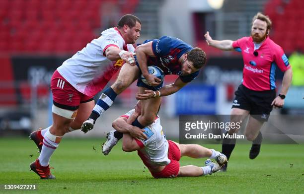 Henry Purdy of Bristol Bears is tackled by Wilco Louw and Will Evans of Harlequins during the Gallagher Premiership Rugby match between Bristol and...
