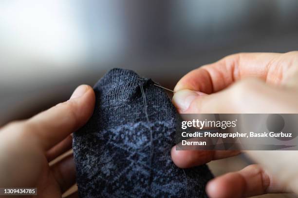 fixing a hole in your sock - sewing stock pictures, royalty-free photos & images