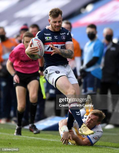 Tom Johnstone of Wakefield escapes the tackle of Brad Dwyer of Leeds during the Betfred Super League match between Wakefield Trinity and Leeds Rhinos...