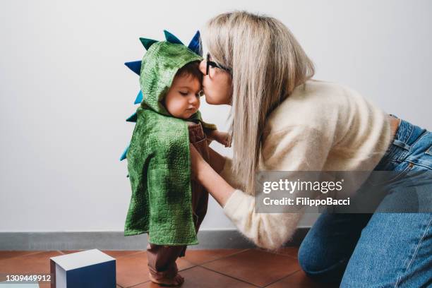 mother is kissing her baby boy at home - kiss of the dragon stock pictures, royalty-free photos & images